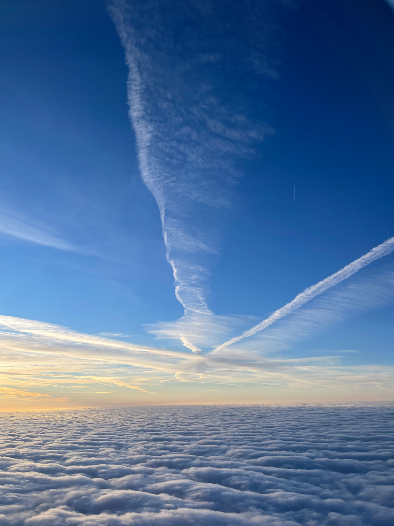 view of the clouds and sun from airplane inspiring to embrace a new perspective